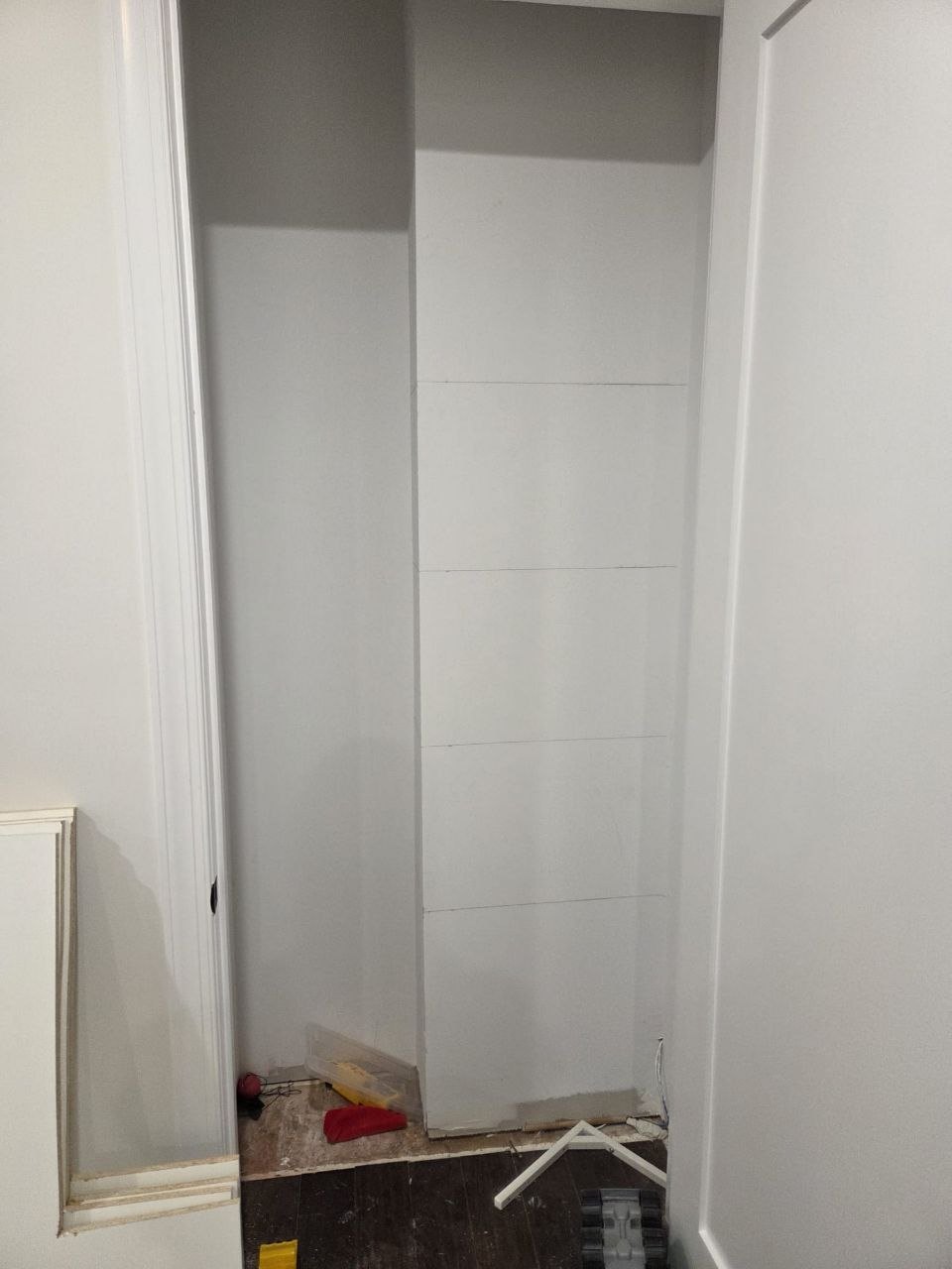 Empty closet with new drywall and no shelves.