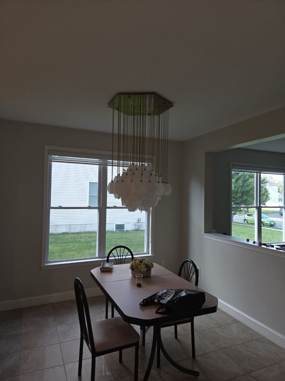 Dining room with a new hanging glass fixture over the table.