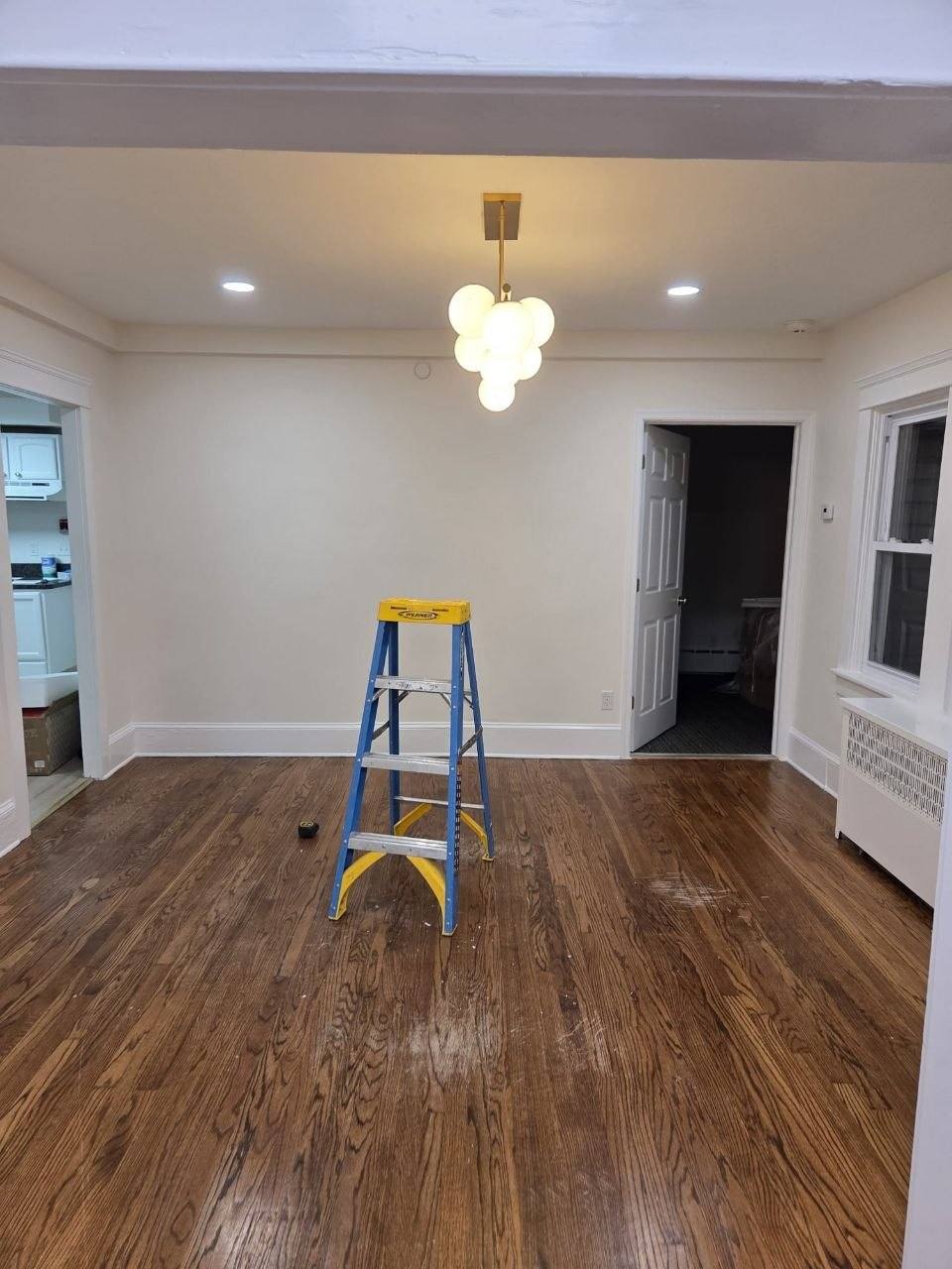 Same room after recessed lights and a new chandelier, ladder still out.