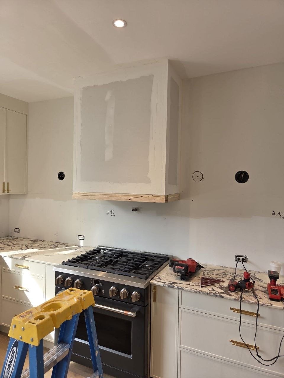 Kitchen range with a drywall hood box being built above it.