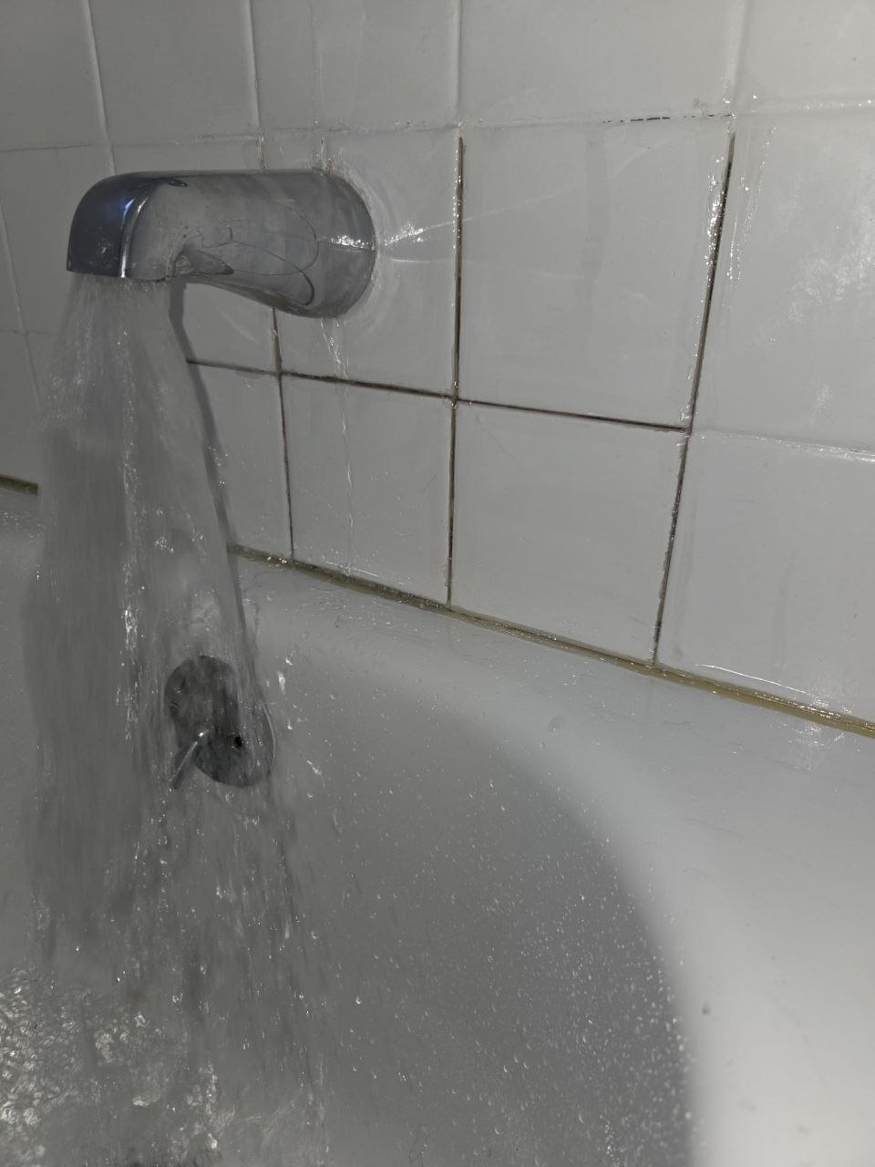 Bathtub spout leaking around the wall plate onto the tile.