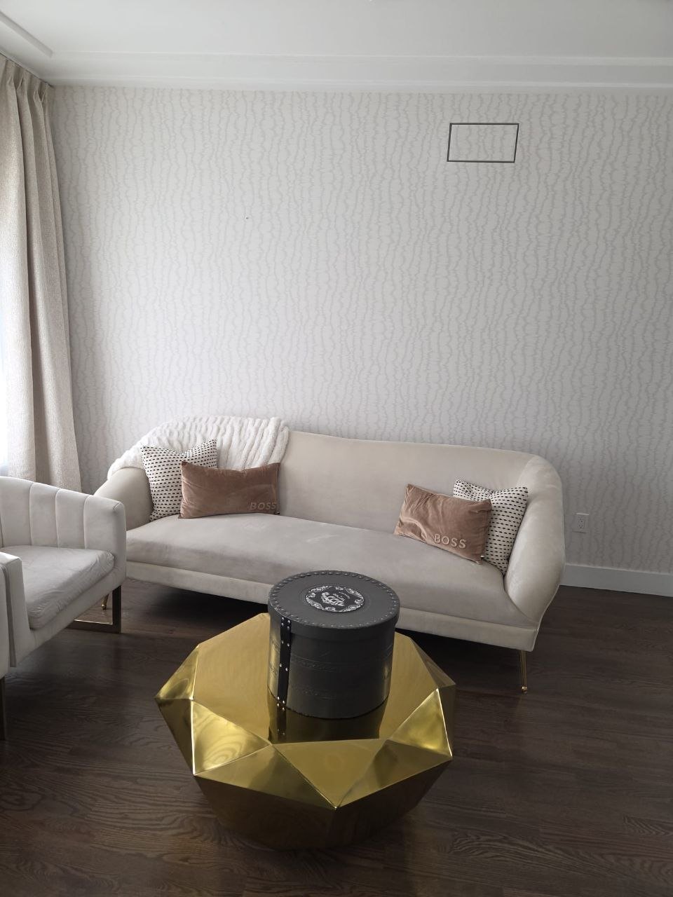 Living room sofa with an empty wall above it.